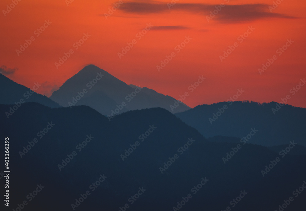 Sunrise behind big mountain silhouette, lake bled Slovenia alps