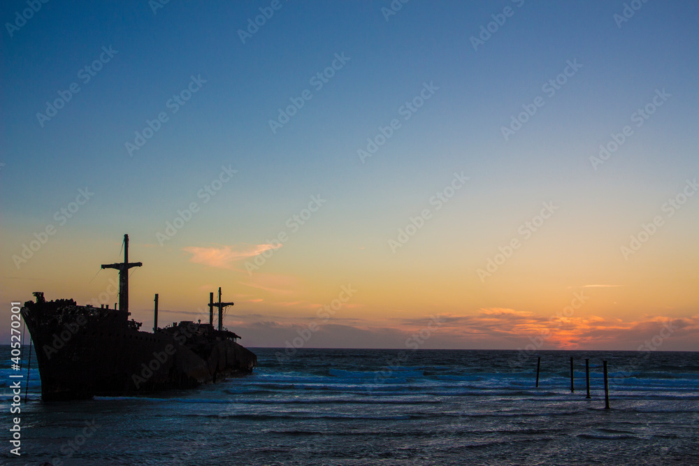 The wrecked ship is sitting on the shore