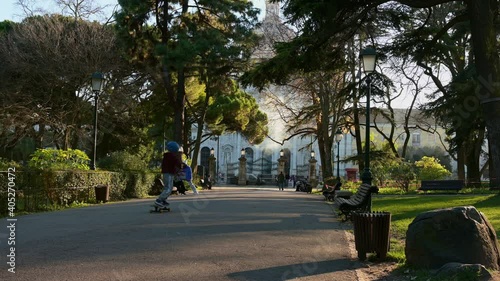  boy riding a skate in a garden in Lisbon