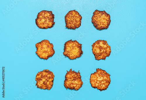 Potato pancakes top view isolated on a blue background. photo