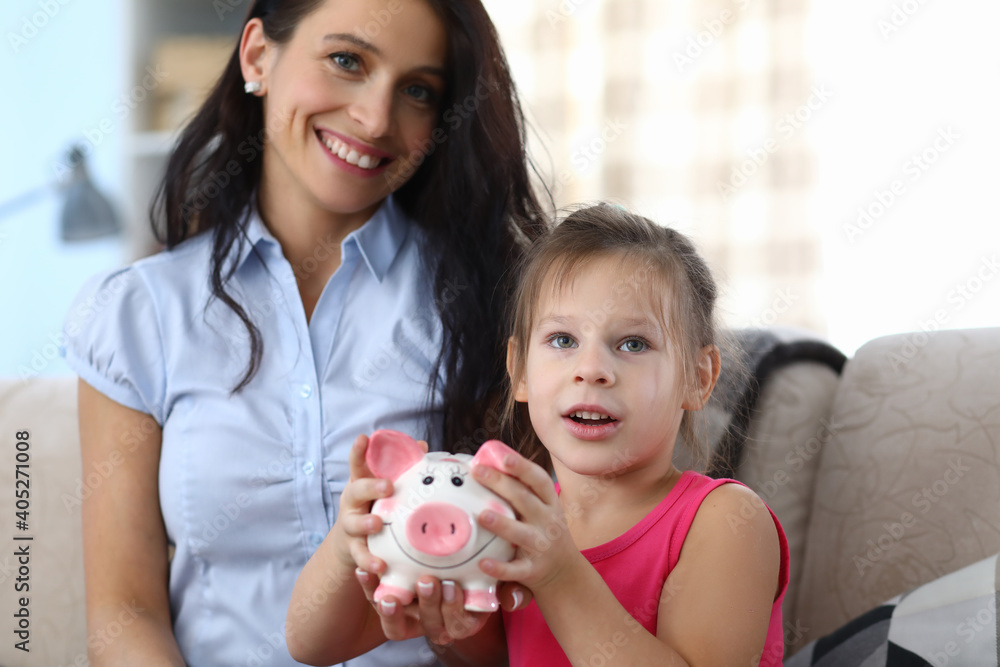 Child holding money box Child holding money box