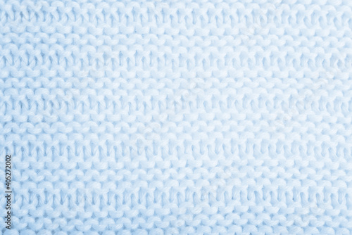Close up of blue knitted textured background. Trendy color.