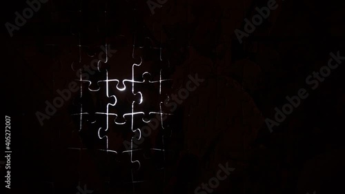 puzzle pieces outline silhouette light movement puzzling situation single piece lit moving fade to black from left to right 