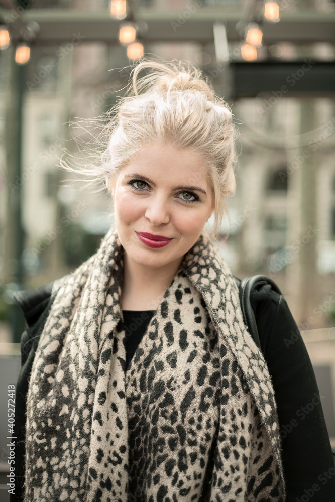 Fashionable woman smiling while standing outdoors Fashionable woman smiling while standing outdoors