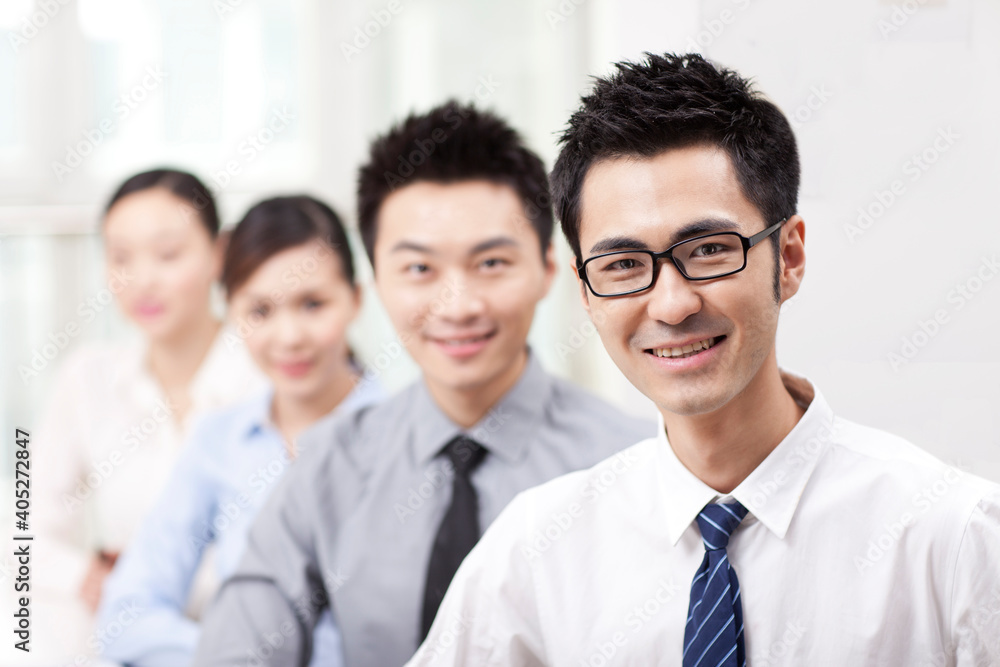 Executives sitting at conference table focus on woman in foreground Executives sitting at conference table focus on woman in foreground