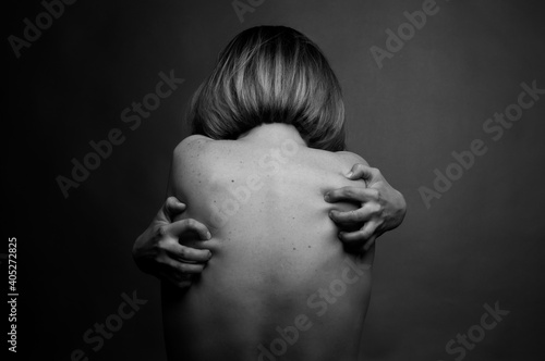 Black and white photo of a nude female back. Art and abstraction.