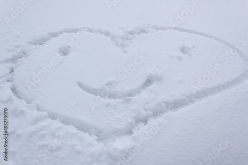 Smiling happy heart symbol on white snow surface wintery day valentines day love and romance card  © АliVa