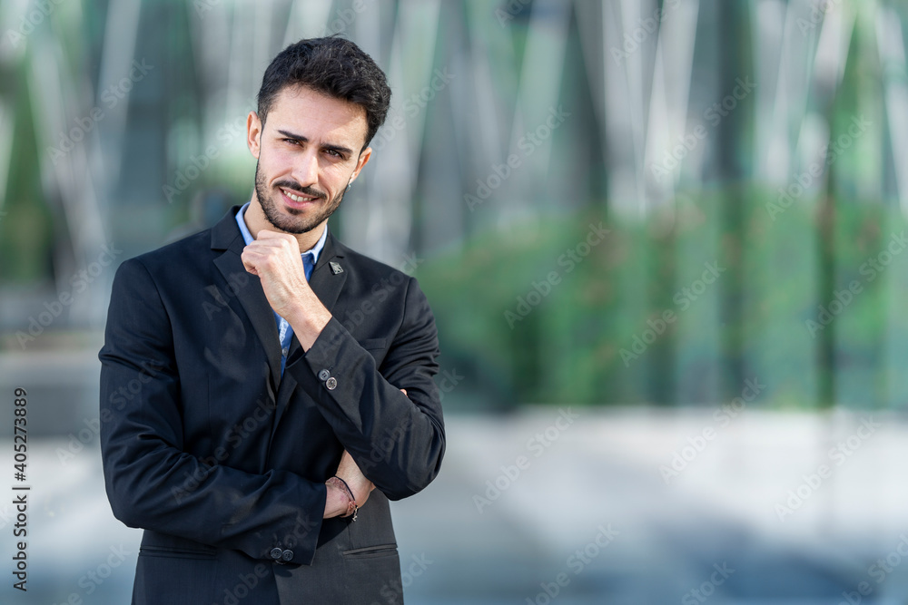 Businessman staring while standing outdoors Businessman staring while standing outdoors