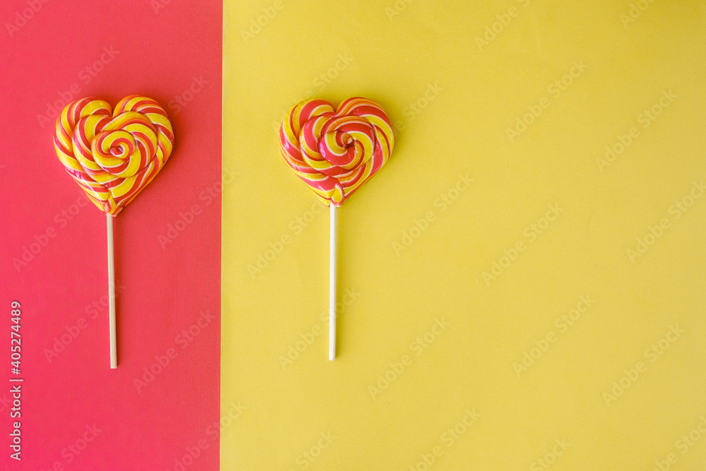 Heart shaped lollypops on the yellow-red background. Heart shaped lollypops on the yellow-red background.