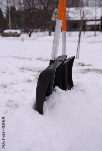 A black snow shovel. Winter blizzard. Cleaning the stairway