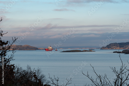 Towing of ships in perfectly calm weather with a nice sunset in progress