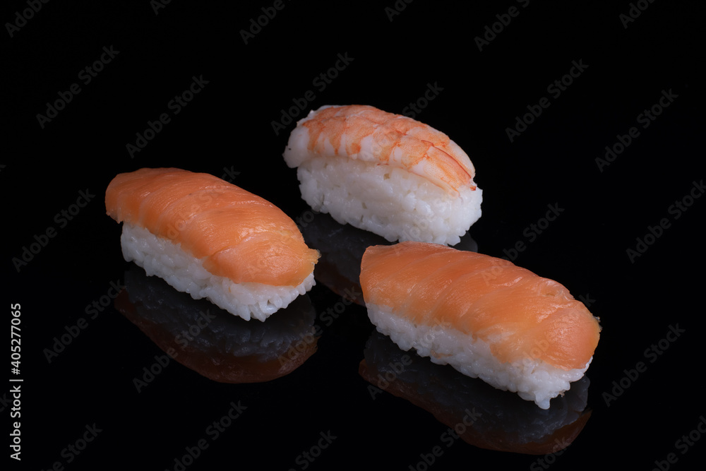 classic sushi with salmon isolated on black with reflection classic sushi with salmon isolated on black with reflection