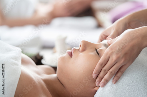 Side View of Asian Woman Receiving Head Massage in a Spa