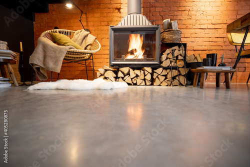 Valokuvatapetti Cozy fireplace with firewood in the loft style home interior with brick wall bac