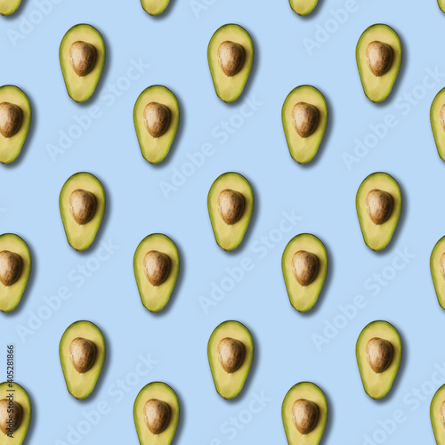 Avocado pattern on light blue background. Green avocadoes, minimal flat lay style. seamless pattern.