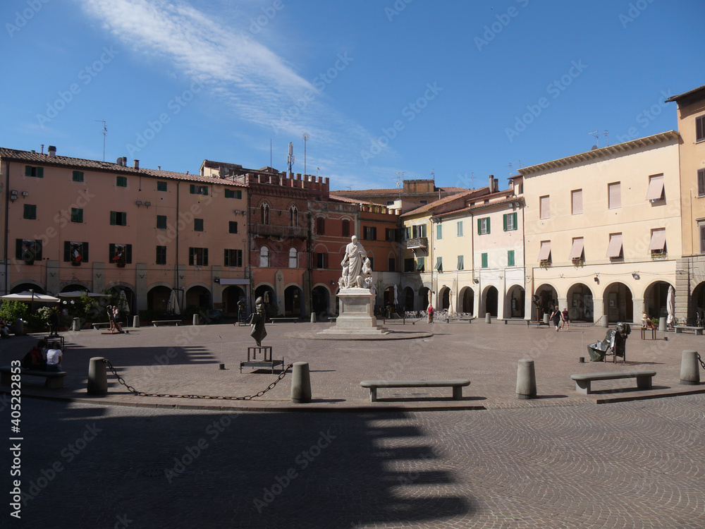 Piazza Dante is the main square of Grosseto with porticos of historic palaces in the background and in the center the statue to Canapone.