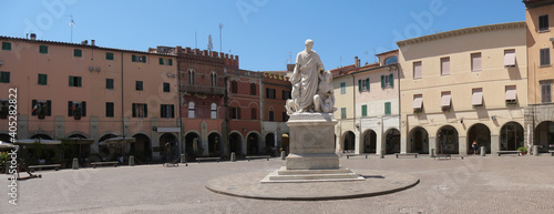 Canvas Print Piazza Dante is the main square of Grosseto with porticos of historic palaces in the background and in the center the statue to Canapone