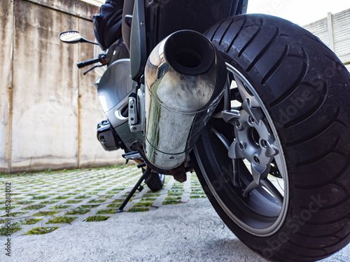 Detail of the left side exhaust of a motorbike