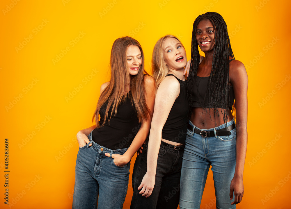 diverse multi nation girls group, teenage friends company cheerful having fun, happy smiling, cute posing on yellow background, lifestyle people concept, african-american, asian and caucasian diverse multi nation girls group, teenage friends company cheerful having fun, happy smiling, cute posing on yellow background, lifestyle people concept, african-american, asian and caucasian