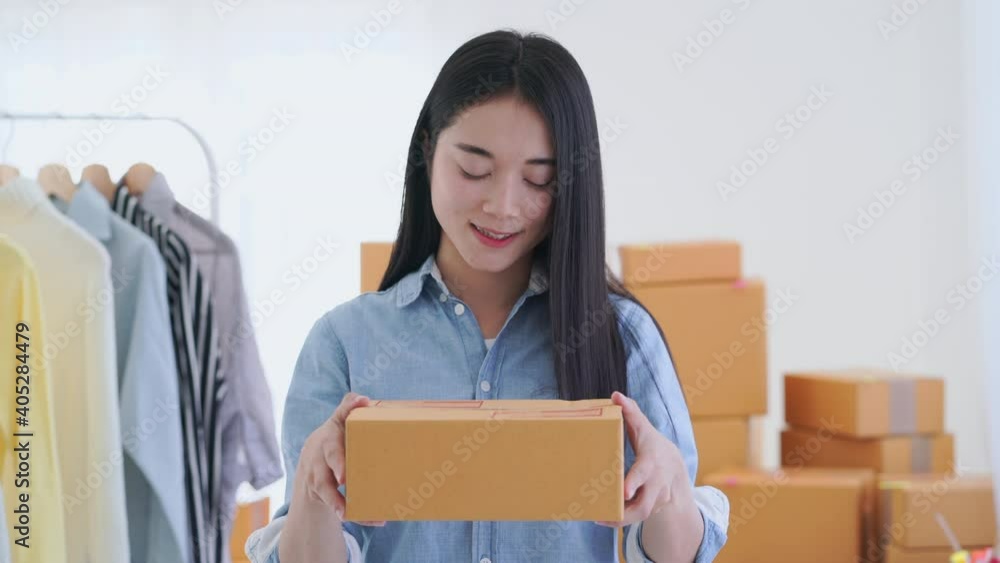 Business woman hands holding and showing a cardboard box package in front of the camera Business woman hands holding and showing a cardboard box package in front of the camera