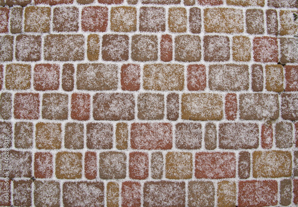 Paving stone texture covered with first snow. stone-block pavement background. Paving stone texture covered with first snow. stone-block pavement background.