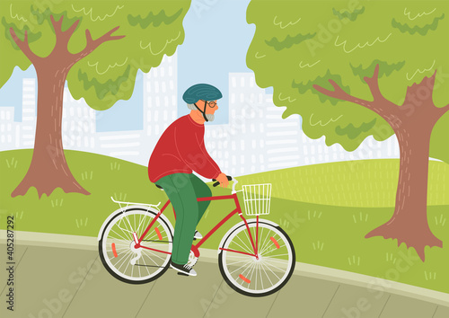 Senior man in helmet riding bike in the city park. Bicycle with basket 