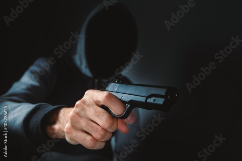 man holds a gun in his hands and threatens
