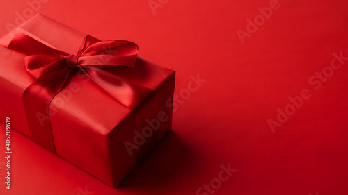 Red gift box on red background, valentine's day gift, special occasion © Teran