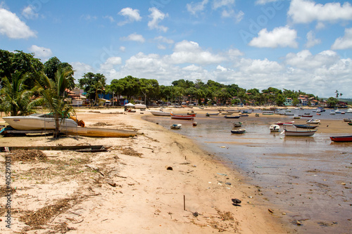 Fishing boats at Coroa Beach (Praia Corcoa) at low tide in the town of Itacare, Brazil