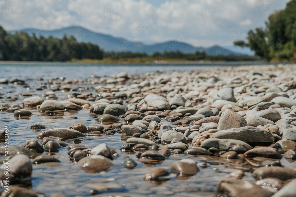 Round stones on the banks of a mountain river. Rocky beach.