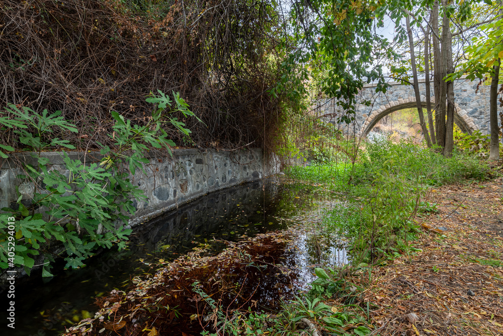 Medieval stoned bridge water flowing in the river in autumn. Medieval stoned bridge water flowing in the river in autumn.
