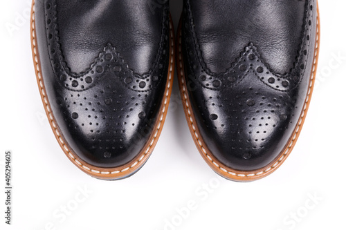 A pair of black patent leather oxford shoes isolated on white background. Versatile business casual dress wingtip. Top view, copy space for text, flat lay.