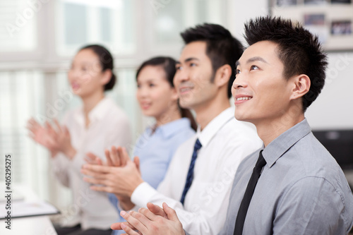 Young Business people applauding in office, smiling 