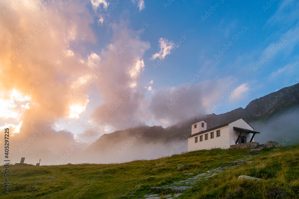amazing clouds during sunset in the mountains and a church (Montafon, Vorarlberg, Austria)