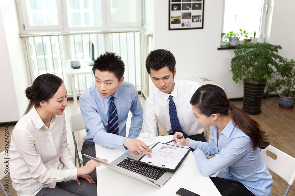 Group of business people discussing in office Group of business people discussing in office