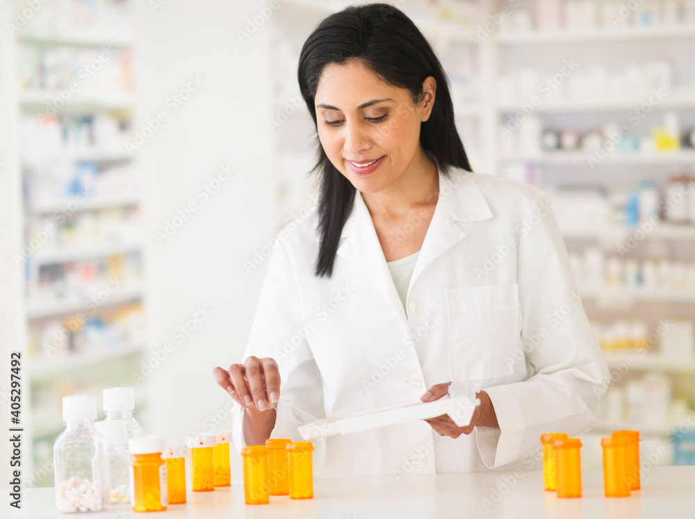 Pharmacist preparing medicines Pharmacist preparing medicines