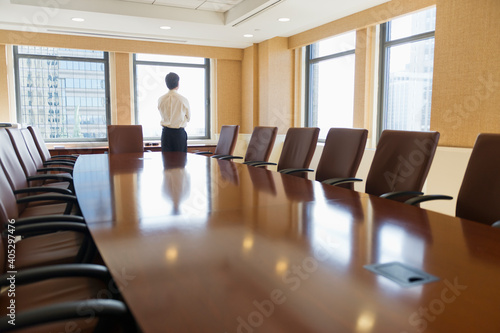 Businessman standing in board room photo