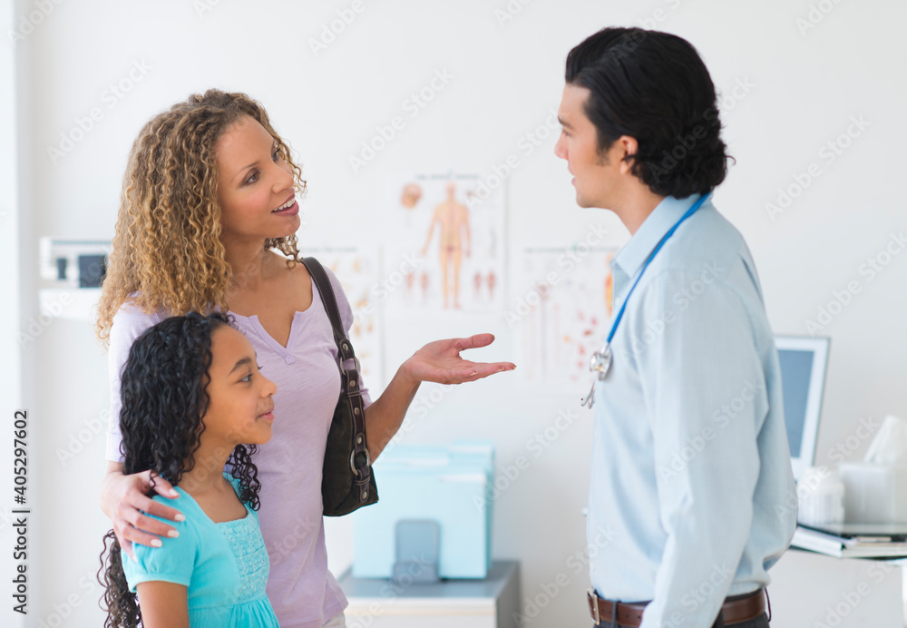 Mother with daughter (12-13) visiting pediatrician Mother with daughter (12-13) visiting pediatrician