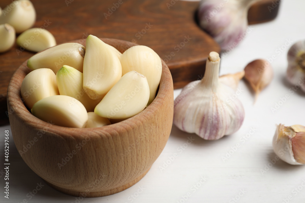 Fresh organic garlic on white table, closeup Fresh organic garlic on white table, closeup