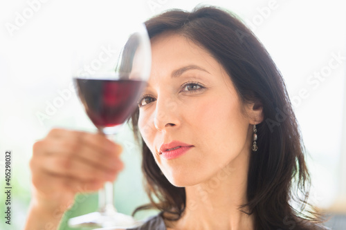 Woman tasting red wine photo