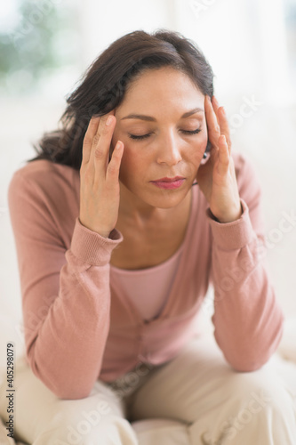 Woman sitting with head in hands photo