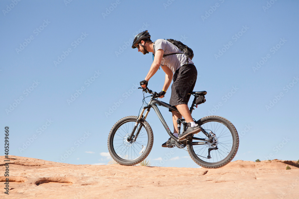 USA, Utah, Moab, Mid adult man riding mountain bicycle in remote scenery USA, Utah, Moab, Mid adult man riding mountain bicycle in remote scenery