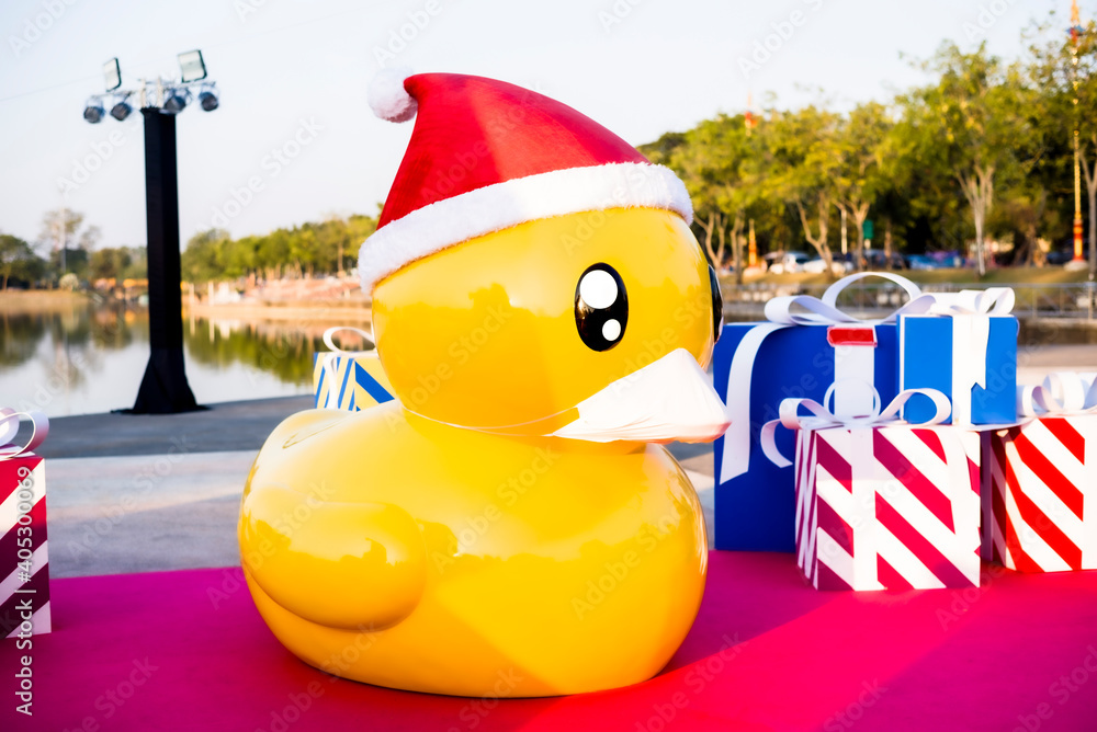 Yellow Giant rubber duck wearing face masks, concept of new normal
