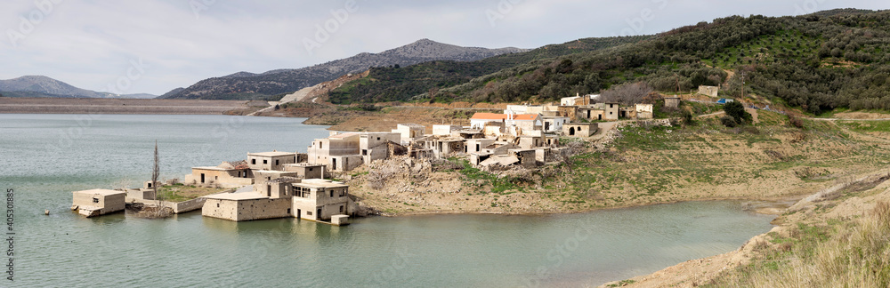 Deserted village on a lake surrounded by mountains (Crete, Greece)