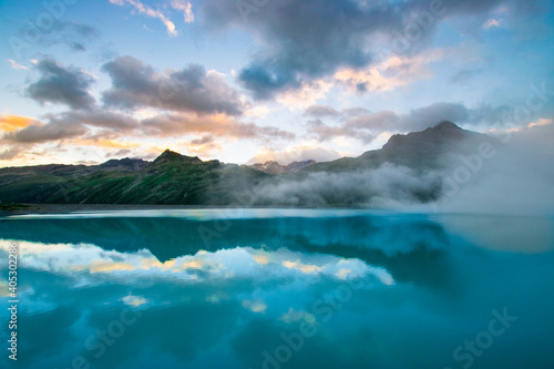 amazing clouds during sunset in the mountains and a lake (Montafon, Vorarlberg, Austria)