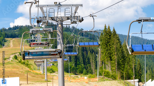 POV video of riding on the ski lift at sunny summer day in mountains photo