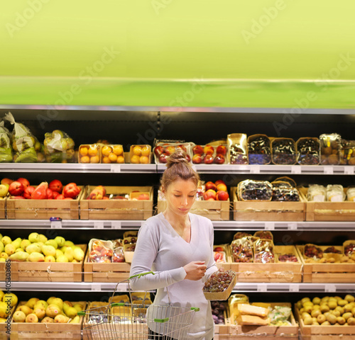Woman buying fruits and vegetables at the market.