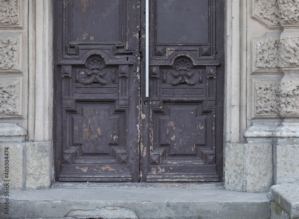 Old vintage brown door. Abstract exterior and interior around the entrance. Doors of city houses.