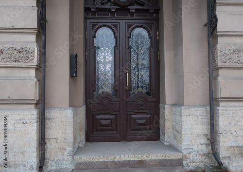Old vintage brown door. Abstract exterior and interior around the entrance. Doors of city houses. © Egor