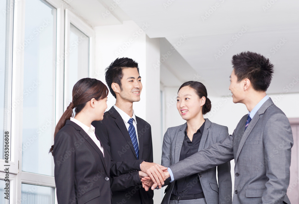Successful business people with their hands together Successful business people with their hands together